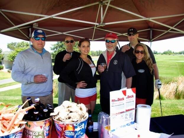 Group posing for photo at Neptune's Invitational Golf Tournament
