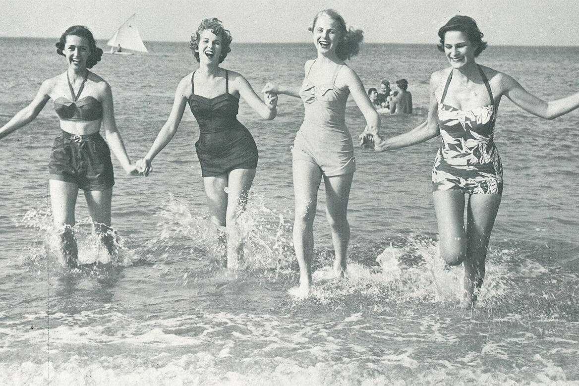 Photo from 1976 Neptune Festival guide of young women running in waves
