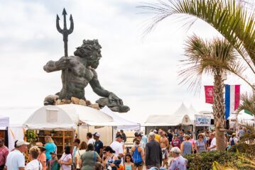 King Neptune statue overlooking crowd gathered on boardwalk for Neptune Festival Art & Craft Show during Boardwalk Weekend