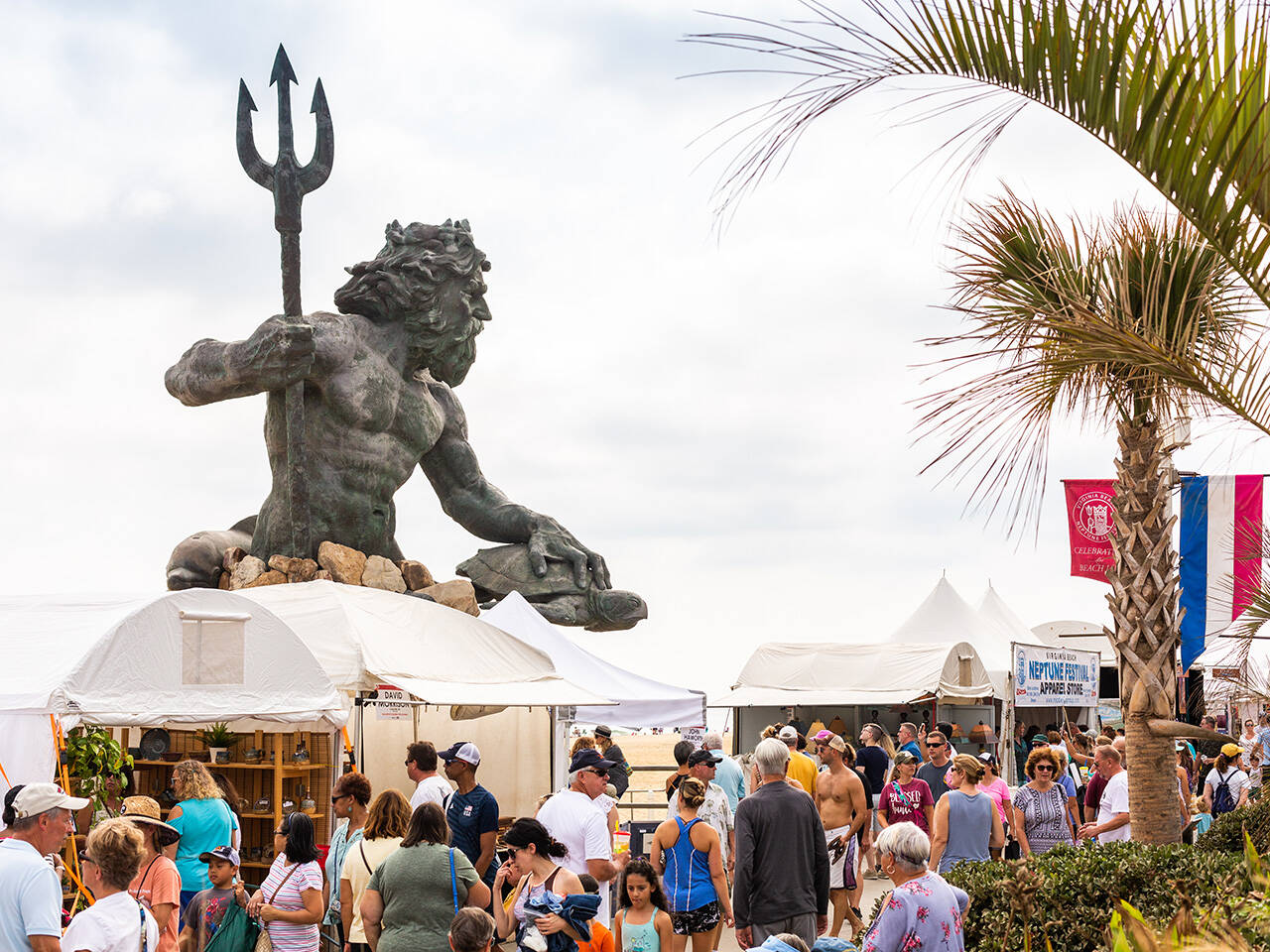 King Neptune statue overlooking crowd gathered on boardwalk for Neptune Festival Art & Craft Show during Boardwalk Weekend