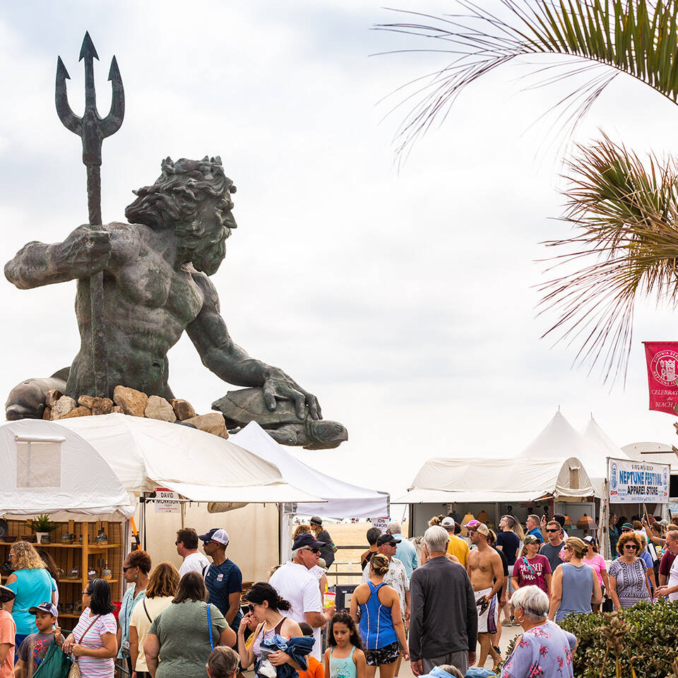 King Neptune statue overlooking crowd gathered on boardwalk for Neptune Festival Art & Craft Show during Boardwalk Weekend