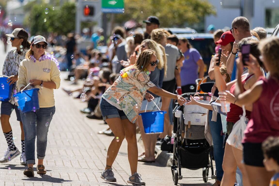 Person passing out treats during Neptune Festival Grand Parade