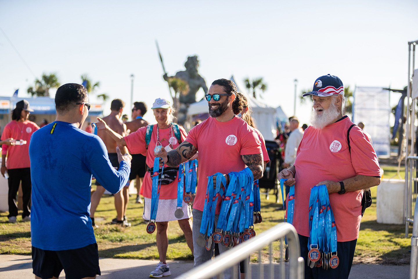 Volunteers handing out medals at Neptune Festival 8K Race