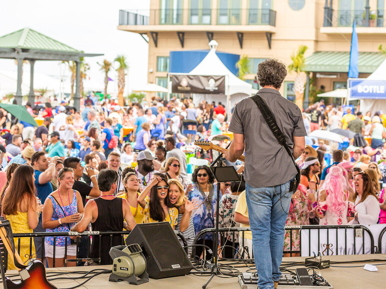 Performer playing music facing crowd at Neptune Festival event