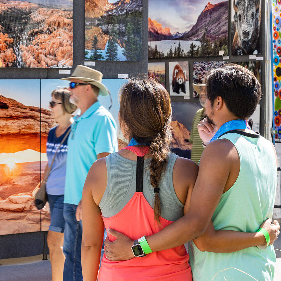 Couple viewing art at Neptune's Art & Craft Show on Boardwalk