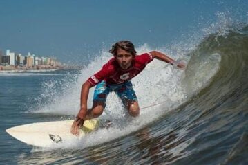 Surfer on wave during Neptune's Surfing Classic