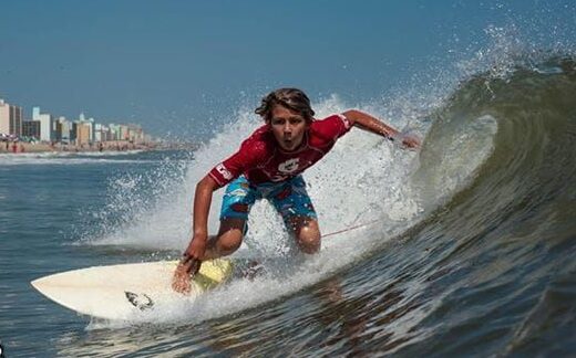 Surfer on wave during Neptune's Surfing Classic