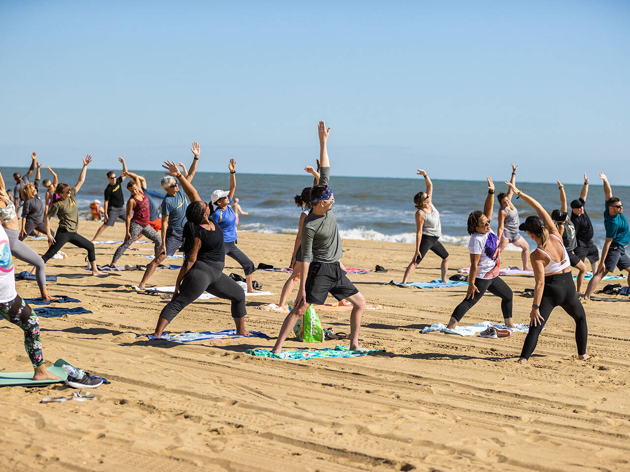 Healthy Haven Group gathered on beach for yoga