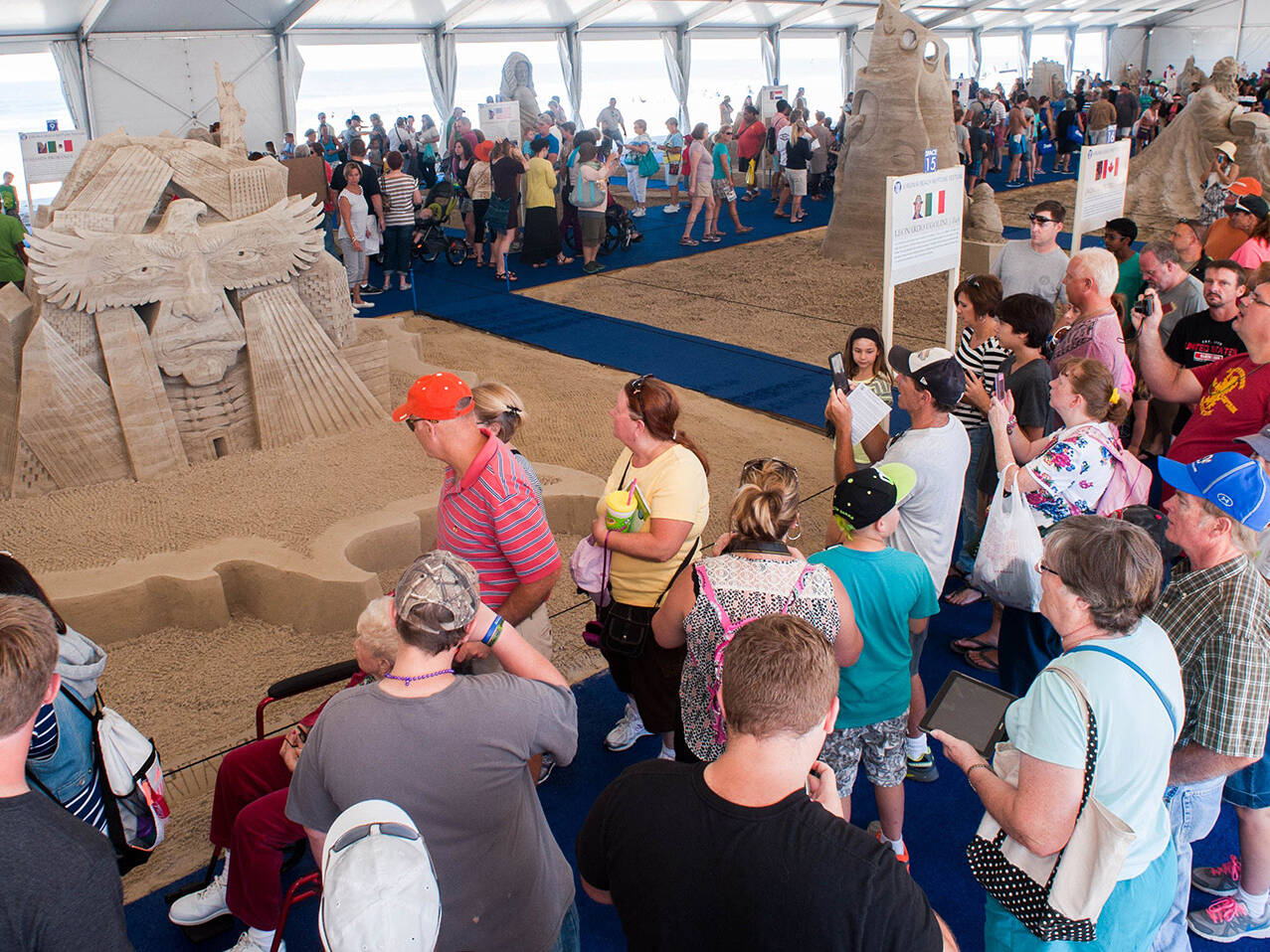 Group viewing Sand Sculptures in tent