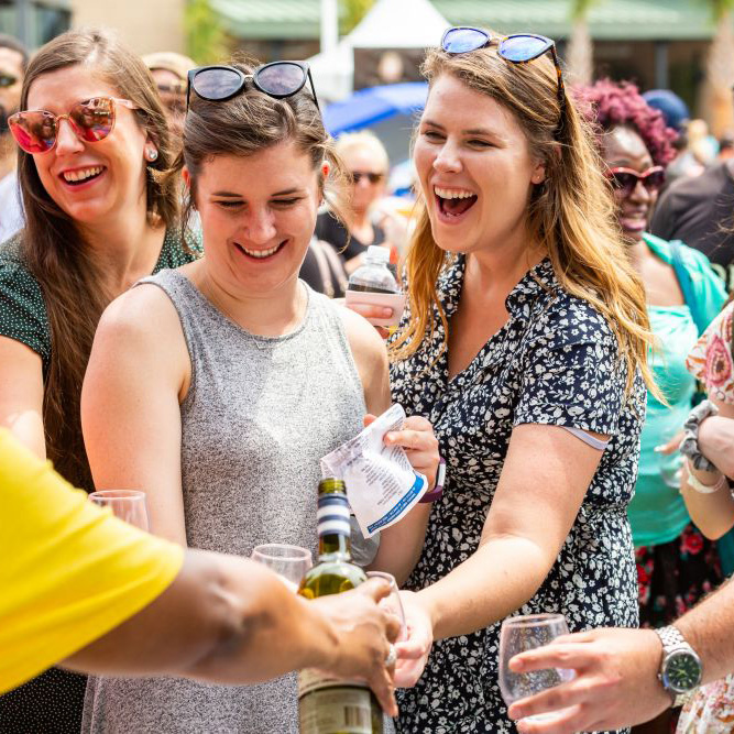 Group of women getting refills at Neptune Festival Wine Festival